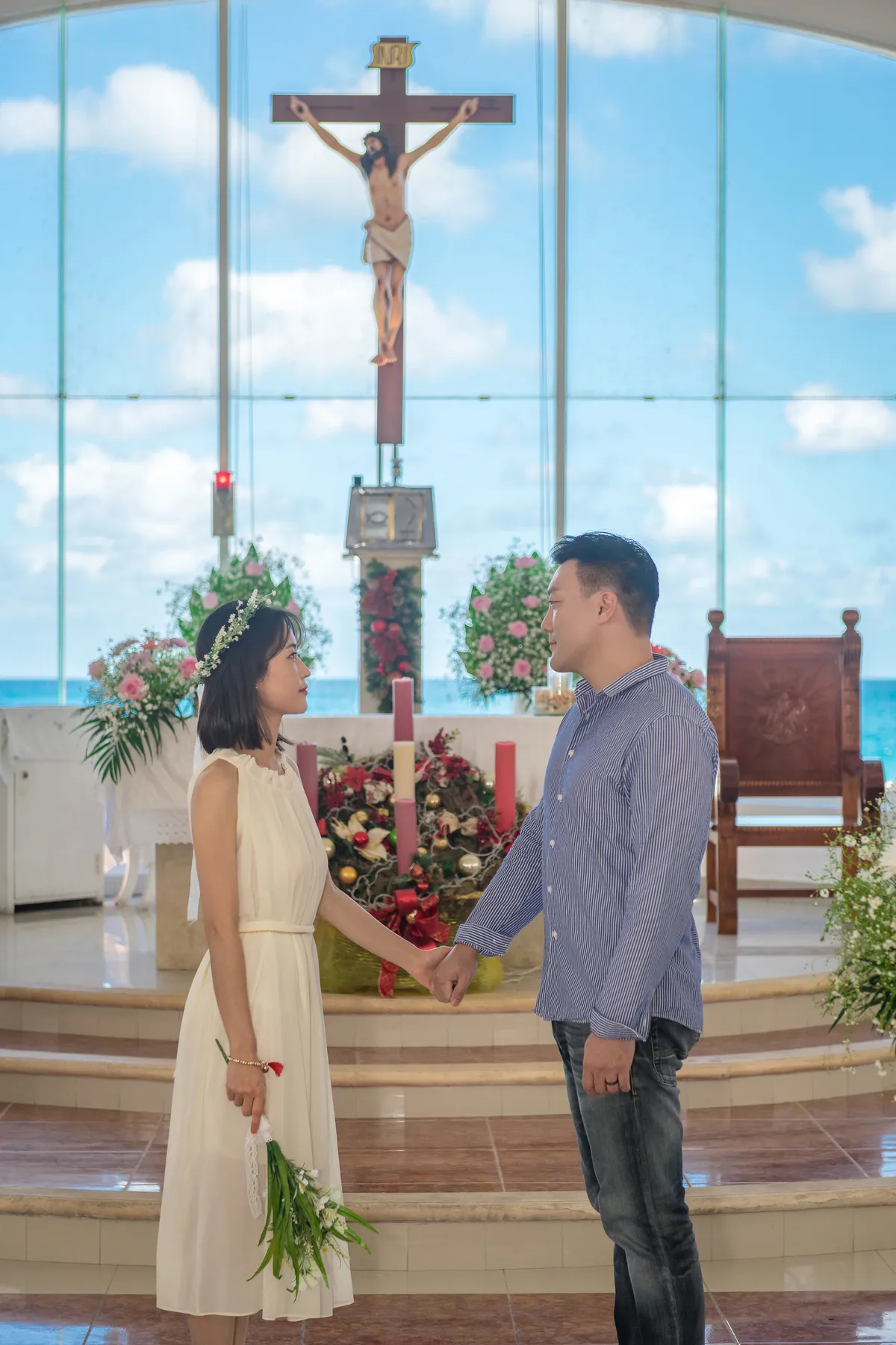 Couple holding hands at the altar of a chapel on Isla Mujeres